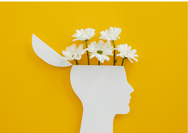 image douce et calme d'un profil d'où sortent des fleurs par le haut de la tête pour exprimer une certaine créativité et libération